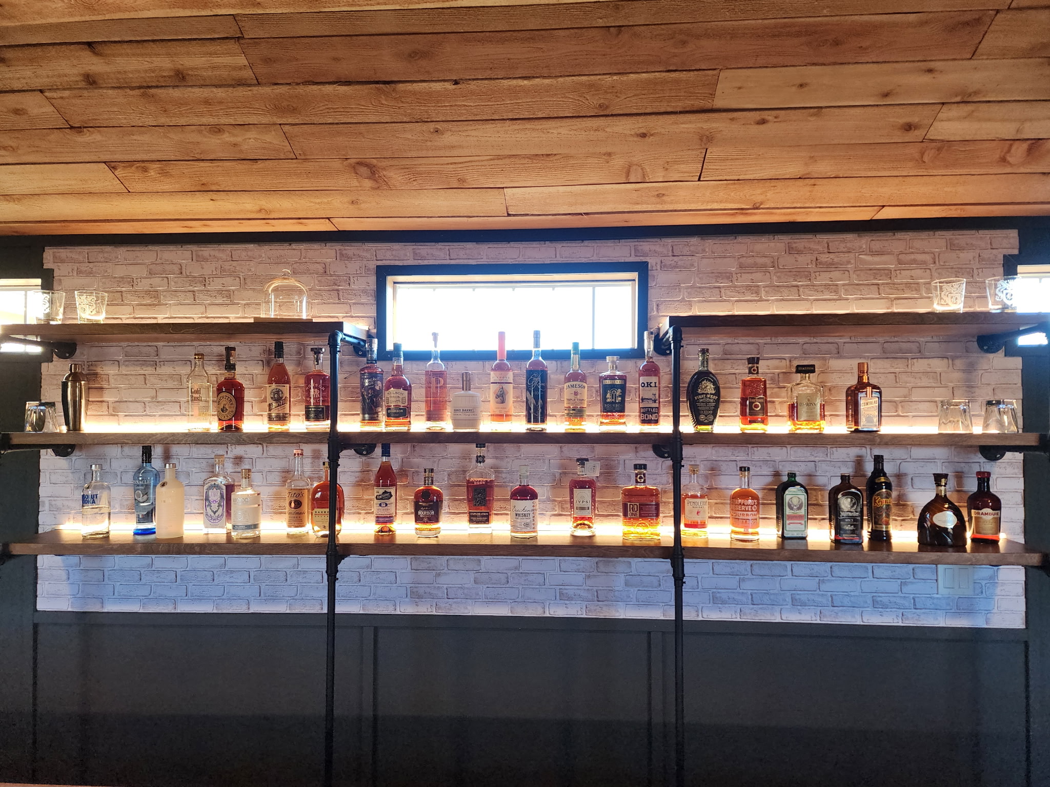 Backlit bar shelves with electrical lighting installation